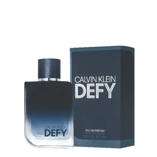 A bottle of Calvin Klein Defy 3.4 EDP for men, with the perfume box beside it.
