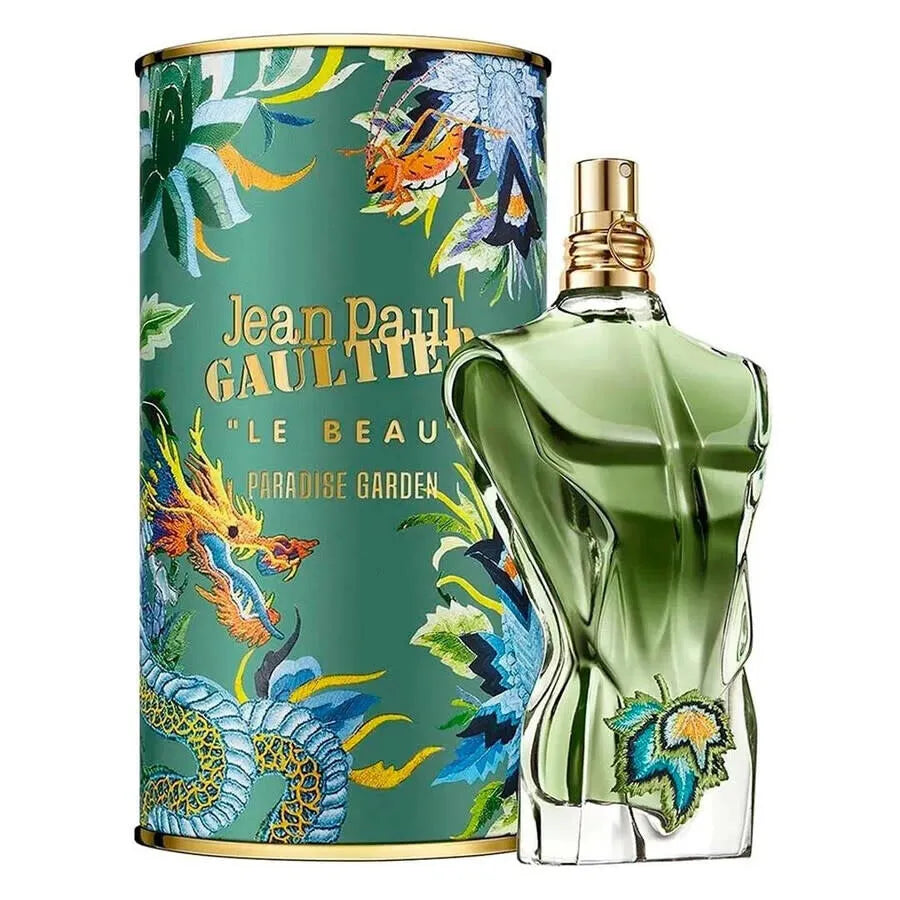 Green perfume bottle with decorative packaging featuring floral designs and text.