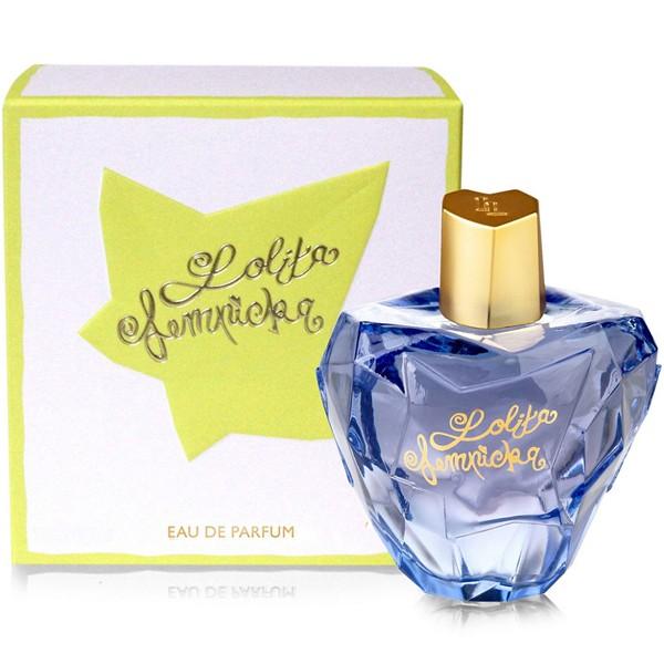 Blue perfume bottle with gold cap and 'Lolita Lempicka' branding next to its packaging on a white background.