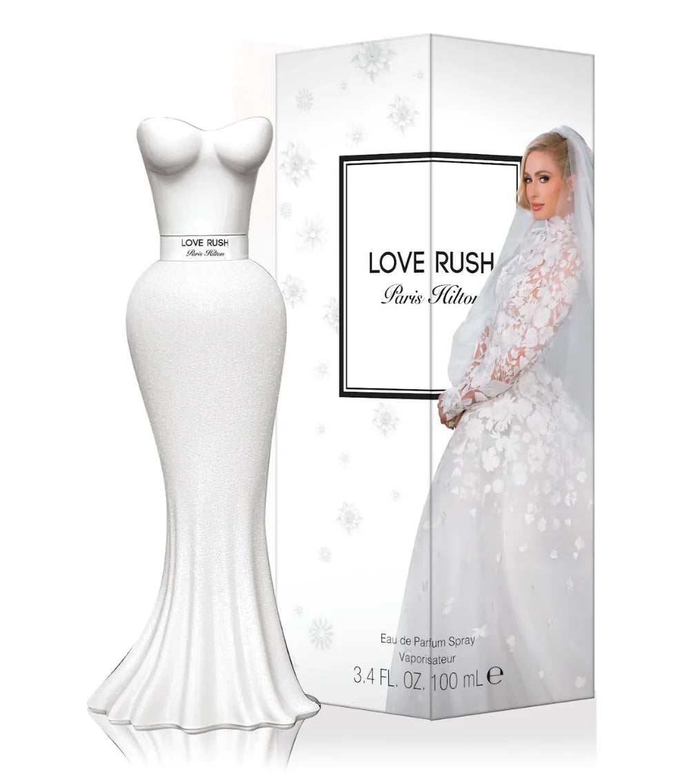 White dress and 'Love Rush' perfume box with a woman in a wedding gown on a white background