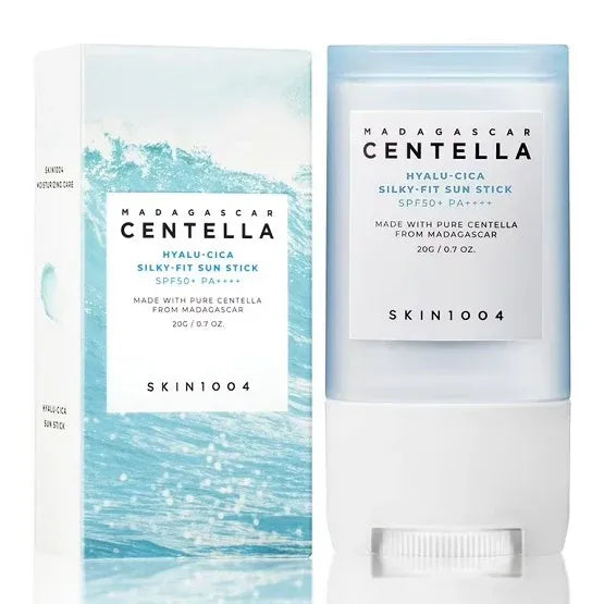 Madagascar Centella Hyalu-Cica Silky-Fit Sun Stick SPF50+ PA++++ by SKIN1004, shown with its white and light blue packaging box and the sun stick container on a white background.